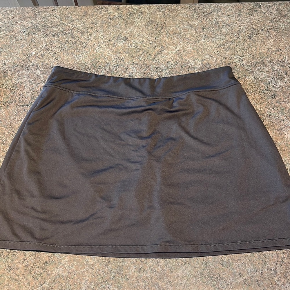 Gray athletic/tennis skirt with built in shorts underneath. Stretchy fabric.